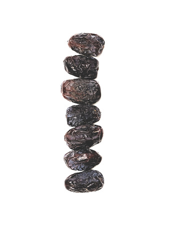 7 Ajwa Dates fruit on white background (Ajwa is a soft dry variety of date fruit from Saudi Arabia.