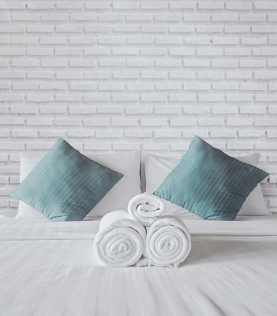 towels on the white bedの写真素材