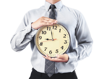 businessman holding a clock in his hand