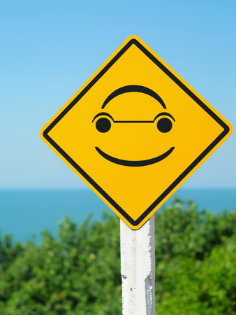 smiley face in yellow road sign