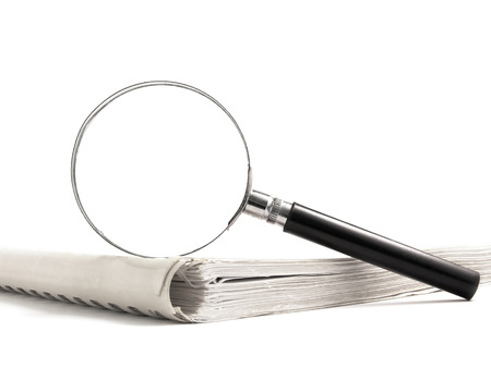 magnifying glass and book on white backgroundの写真素材
