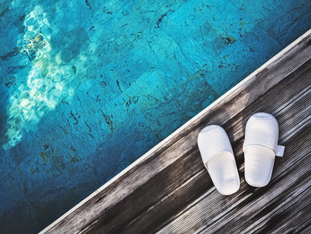 white slippers at pool sideの写真素材
