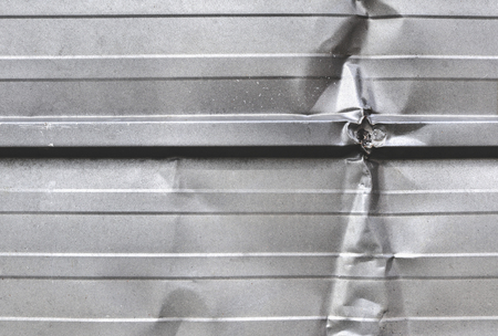 wrinkled silver metal sheet wallの写真素材