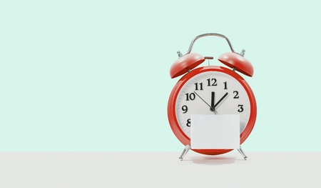 paper with red alarm clock on color backgroundの写真素材