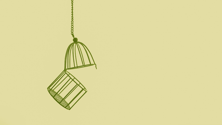 green bird cage isolated on yellow backgroundの写真素材