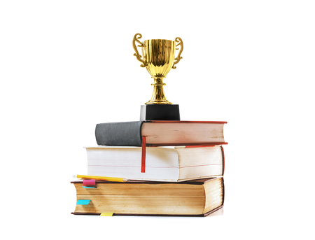 Trophy and book with pencil on white backgroundの写真素材