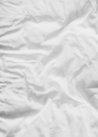 messy white bed sheets backgroundの写真素材