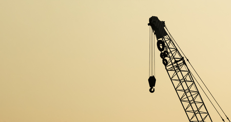 silhouette of crane against warm sky backgroundの写真素材