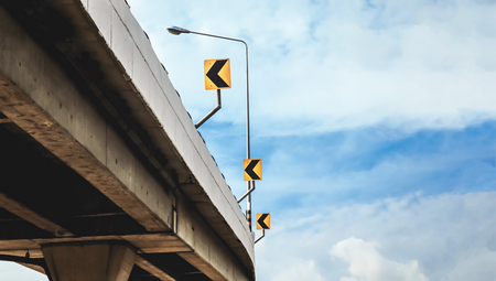 curve road sign on the bridge with sky background