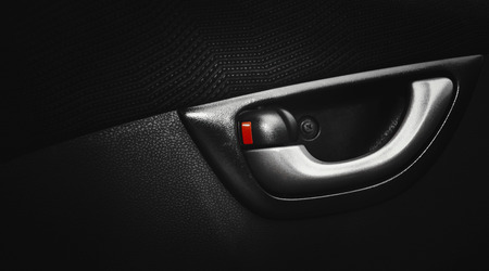 red locking button with door handle inside the car
