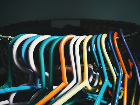 colorful hangers hang on the basketの写真素材