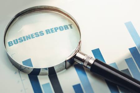 magnifying glass focus on business financial reportの写真素材