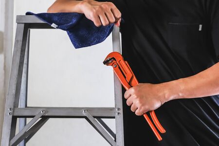 wrench in hand of technician repairingの写真素材