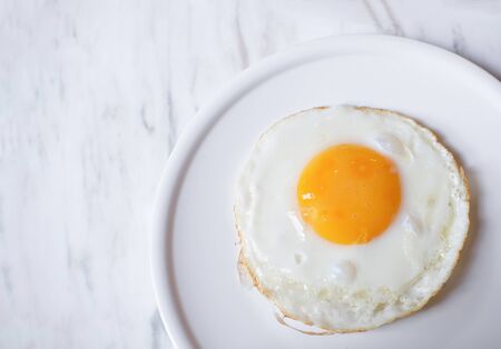 fried egg on white plateの写真素材