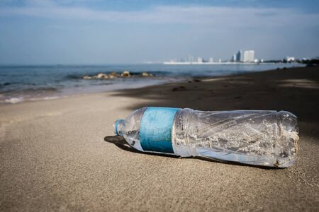 plastic garbage water bottle on the sand beachの写真素材