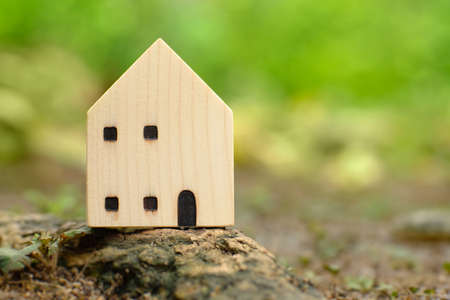 homes that blend perfectly with nature. model house with blurred green background. ideas about buying, selling, or renting a home. natural environment with habitat.の写真素材