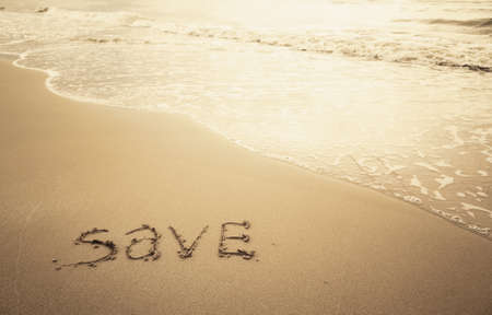 save the beach. sea and ocean recovery concept. save word on the golden sand. environmental protection concern.の写真素材