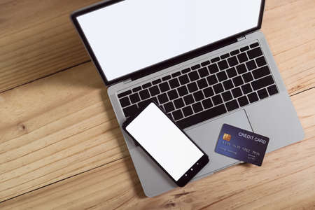 credit card and mobile phone on a laptop for e-commerce. digital online shopping payment. internet banking.の写真素材