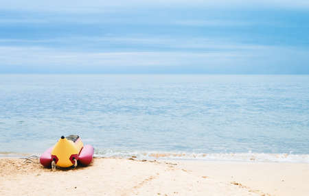 Banana boat for tourists on the sandy beach. Fun activities on the water with inflatable boats. Sea...