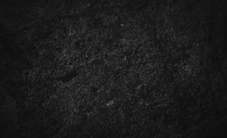 Dark black rock texture. The geology of the surface of the cave wall. Rough stone background. Natural backdrop.の写真素材
