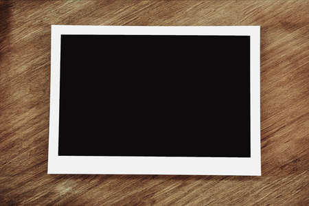 Picture frame mockup design. Empty photo on wooden background.の写真素材