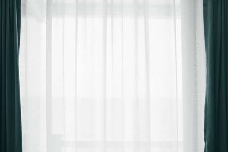 Bright and soft morning light through the white curtain. Home living and interior decoration. luxury background. The windows are decorated in an elegant style.の写真素材