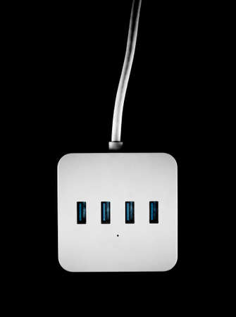 Top view of white portable USB hub on black background. Data transfer gadget.の写真素材