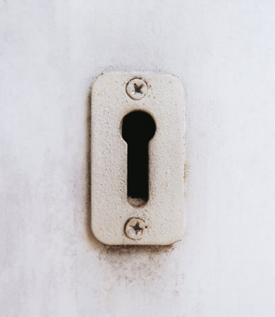 Antique keyhole on an old wooden door. Vintage lock symbol. Exit or solution concept. Problem solving.の写真素材