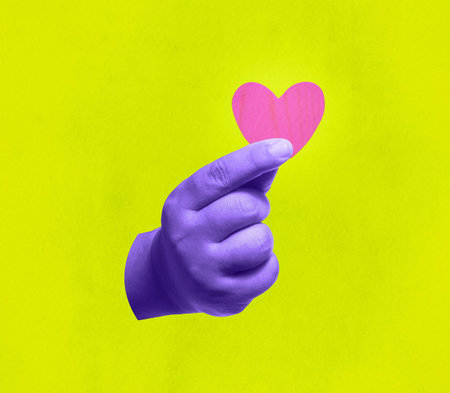 Hand holding a heart symbol. Giving love and care. Collage style with colorful pop art.の写真素材