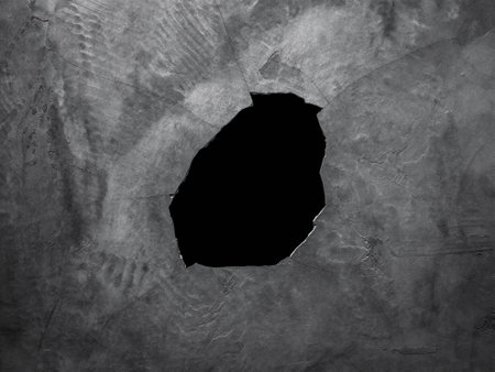 Cracked and damaged cement wall. Broken concrete background. Hole in the ceiling.の写真素材