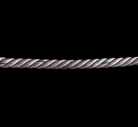 Strong rope isolated on a black background. String in the dark.の写真素材