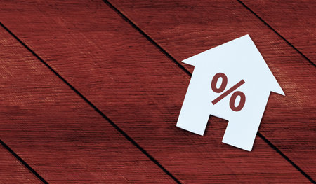 House symbol on wooden background. Property investment and valuation. Residential price and tax. Real estate market. House renovation vat. Home appraisals cost. Housing prices.の写真素材