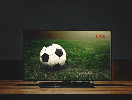 Live football game broadcasts in real time through the Internet and media television. Watching soccer sport match in tv.の写真素材