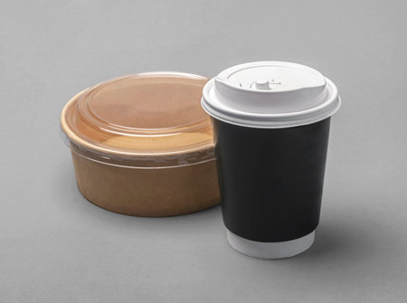 Disposable paper container with plastic lid. Takeaway food meal. Recyclable material. Eco friendly packaging. Rice bowl and coffee cup.の写真素材