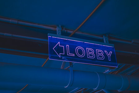 Illuminated signs pointing the way to the lobbyの写真素材