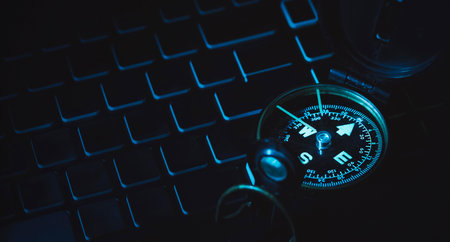 Compass on laptop in the dark. Direction for managing work planning. Future of education. Marketing and economic trends. Content creation strategy.の写真素材