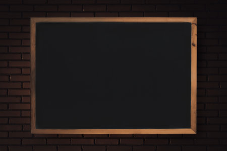 Blackboard on a brick wall background. Tutoring classroom. Learning backdrop. Educational concept.