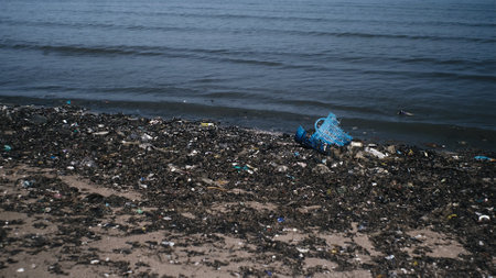 Waves of trash on the beach. Plastic pollution in the sea. Water environmental crisis.. Plastic...
