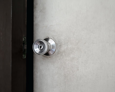 Gently open the wooden door into a dark room. Old handle doorknob.の写真素材