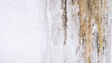 Dirty stain stuck on the walls of the house. Old cement wall backdrop. Dirt that corrodes the building surface and causes damage.の写真素材