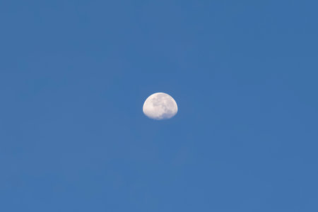 Moon in the morning blue sky. Lunar during the day in winter.の写真素材