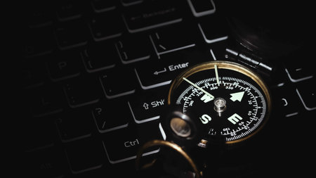 Compass on laptop in the dark. Direction for managing work planning. Marketing and economic trends. Business strategy.の写真素材