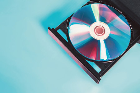 Nostalgia of computer information technology. DVD Compact disc in retro and futuristic color style. Data storage. CD rom drive.の写真素材