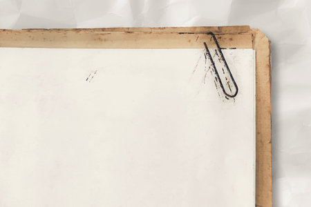 Old paper sheet surface background. Documents and rusty paper clip.