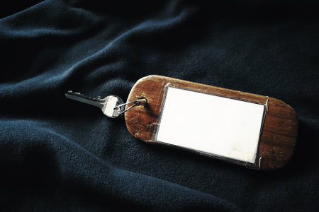 Hotel room key tag on the blanket on the bed.の写真素材