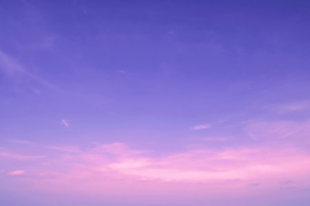 Cloudy pink sky. Soft stratus clouds. Light blue pink nature background. Dawn scenic weather.の写真素材