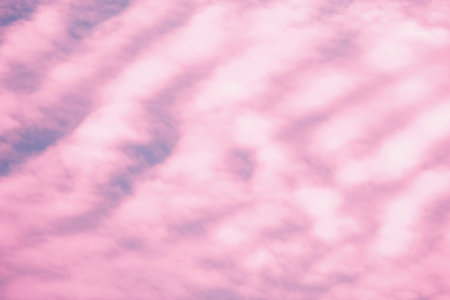 Dreamy pink cloudy sky. Soft light clouds. Nature background. Sunset scenic weather.の写真素材