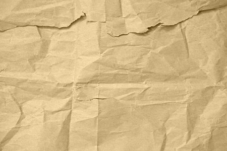 Crumpled brown paper texture for use as a natural background, eco-friendly packaging concept, or vintage style design element.の写真素材