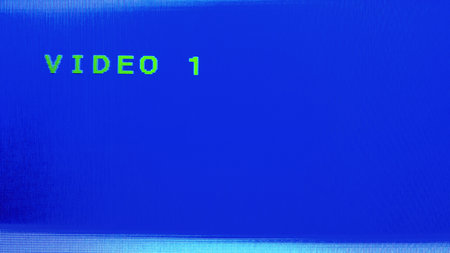 CRT television displaying the "VIDEO 1" input on blue background. No signal screen. Nostalgia of retro vhs technology. Feeling from the past.の写真素材