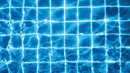 Top view of swimming pool water with bright reflections and blue tile grid, clean summer background...